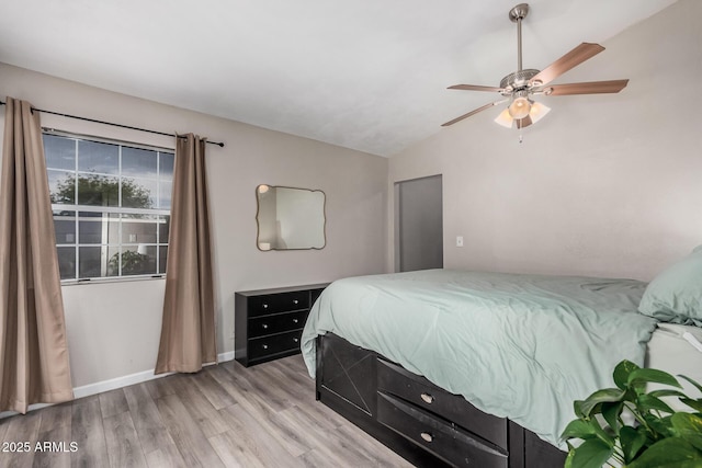 2929 E Broadway Rd Unit 30, Mesa, AZ 85204 - bedroom with light wood-type flooring, lofted ceiling, baseboards, and a ceiling fan