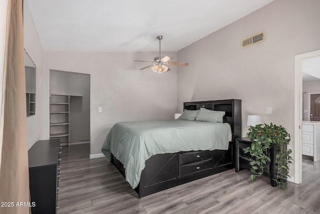 2929 E Broadway Rd Unit 30, Mesa, AZ 85204 - bedroom with wood finished floors, vaulted ceiling, baseboards, and ceiling fan