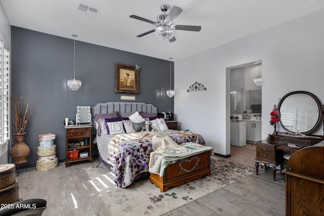 bedroom featuring ceiling fan, connected bathroom, and light wood-type flooring