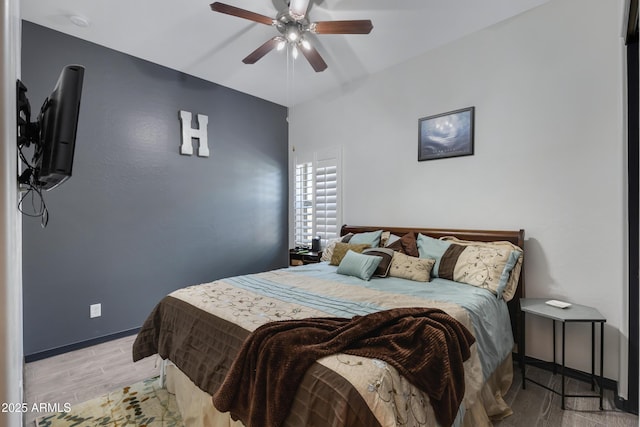 bedroom with ceiling fan and light hardwood / wood-style floors