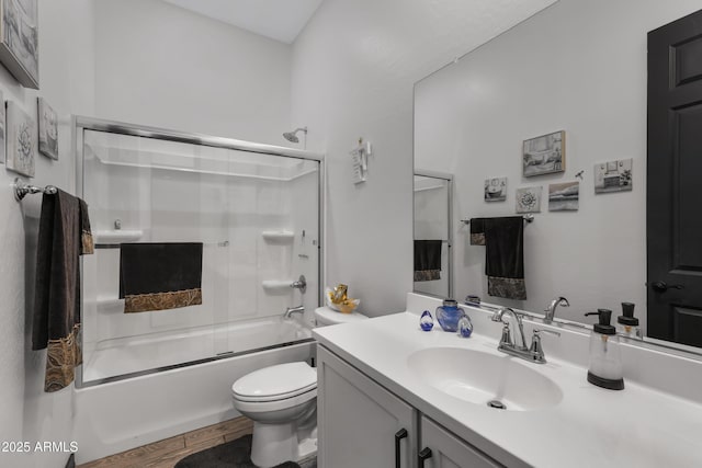 full bathroom with toilet, enclosed tub / shower combo, wood-type flooring, and vanity