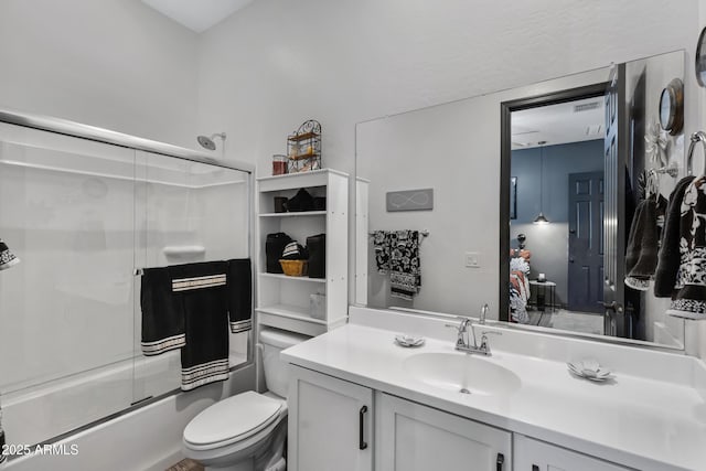 full bathroom featuring toilet, bath / shower combo with glass door, and vanity