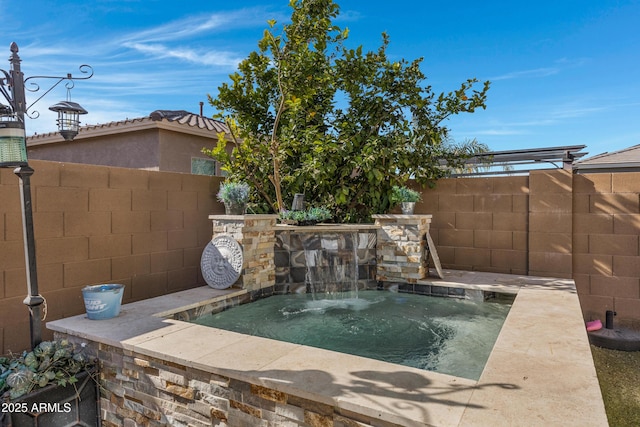 view of swimming pool with a hot tub and pool water feature