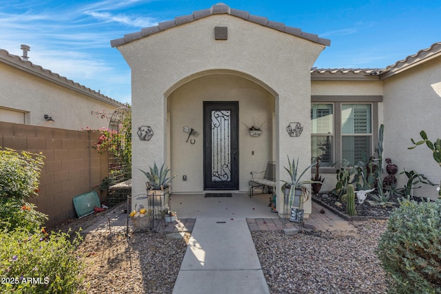 property entrance featuring a patio