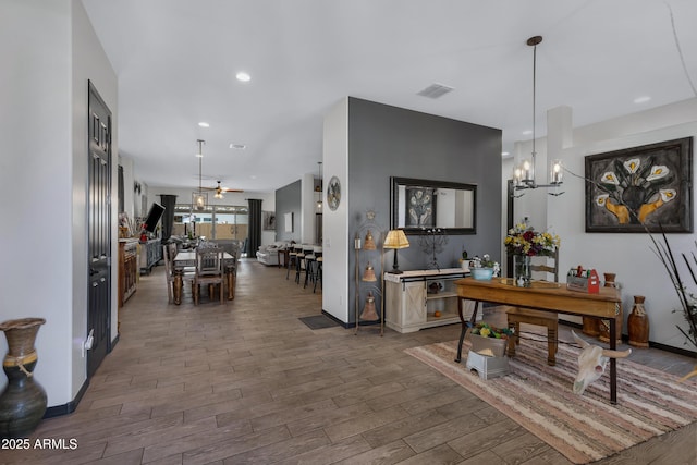 dining area with ceiling fan with notable chandelier