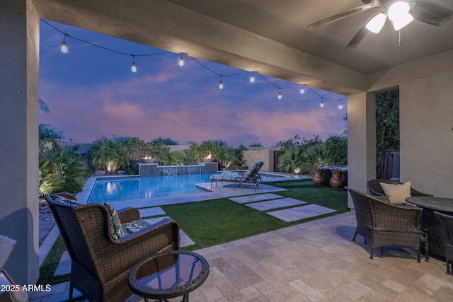 2339 E Questa Dr, Phoenix, AZ 85024 - patio terrace at dusk featuring ceiling fan, a yard, and an outdoor pool