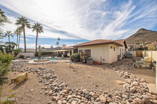 1908 E Beck Ln, Phoenix, AZ 85022 - rear view of property featuring a fenced backyard, stucco siding, a tiled roof, a patio, and a mountain view