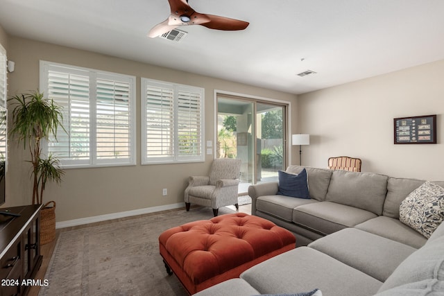 living room featuring ceiling fan and hardwood / wood-style flooring