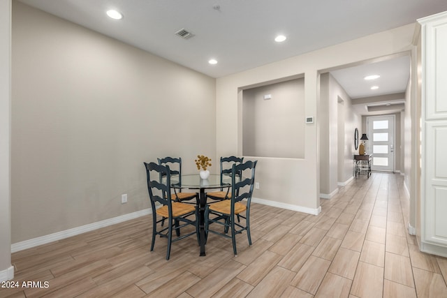 dining space with light hardwood / wood-style floors