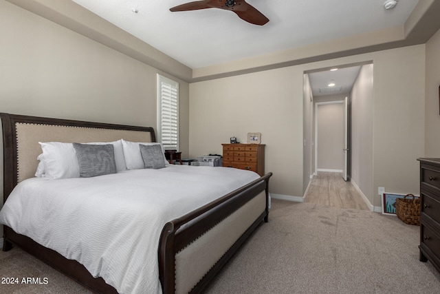 bedroom featuring light carpet and ceiling fan