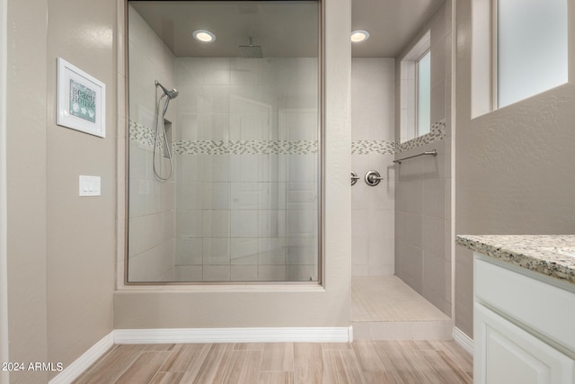 bathroom featuring vanity and a tile shower