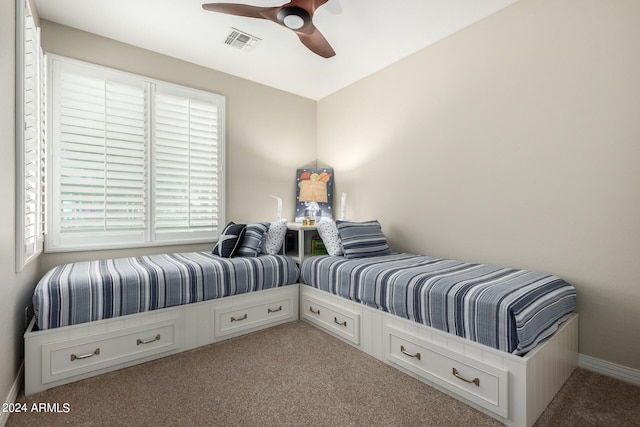 bedroom featuring light colored carpet and ceiling fan