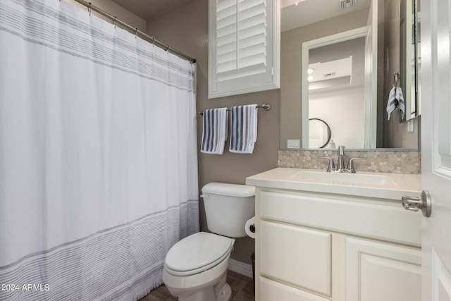 bathroom with walk in shower, vanity, and toilet