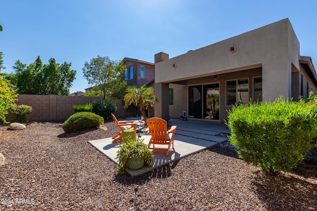 back of property featuring ceiling fan and a patio area