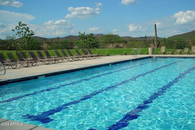 view of swimming pool featuring a mountain view