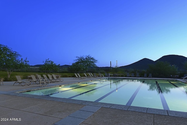 view of swimming pool with a mountain view and a patio