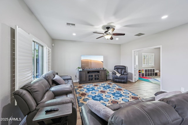 living area with recessed lighting, visible vents, ceiling fan, and light wood-style flooring