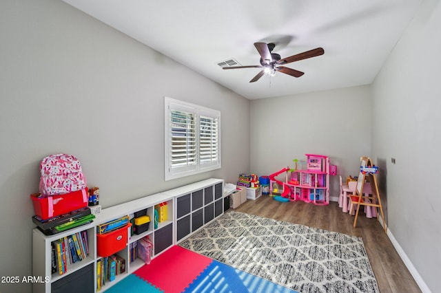 playroom with visible vents, baseboards, ceiling fan, and wood finished floors