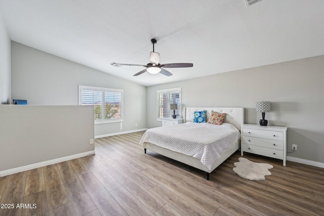 bedroom with vaulted ceiling, ceiling fan, baseboards, and wood finished floors