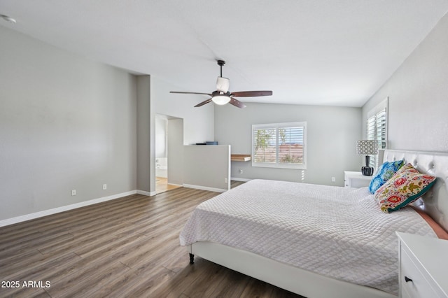 bedroom featuring ceiling fan, baseboards, wood finished floors, and vaulted ceiling