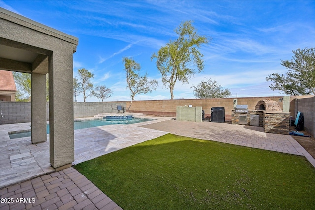 view of yard with a patio, a fenced backyard, a fenced in pool, and an outdoor kitchen