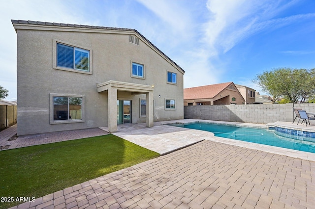 view of pool featuring a patio, a fenced backyard, a fenced in pool, and a lawn