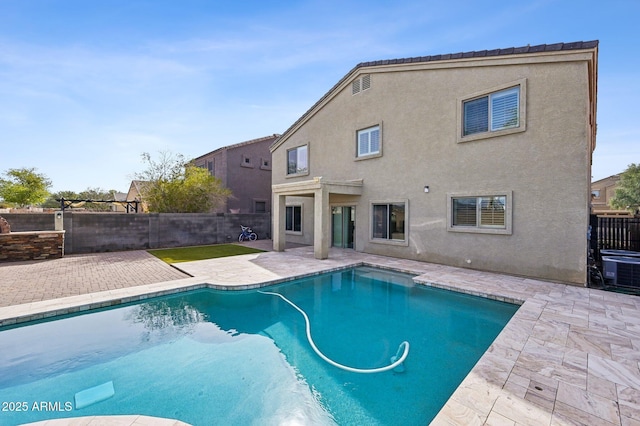 view of swimming pool with a fenced backyard, central AC unit, a fenced in pool, and a patio