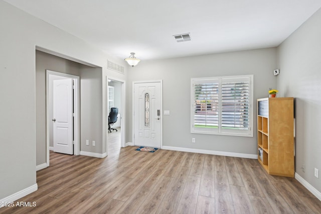 entryway featuring wood finished floors, visible vents, and baseboards