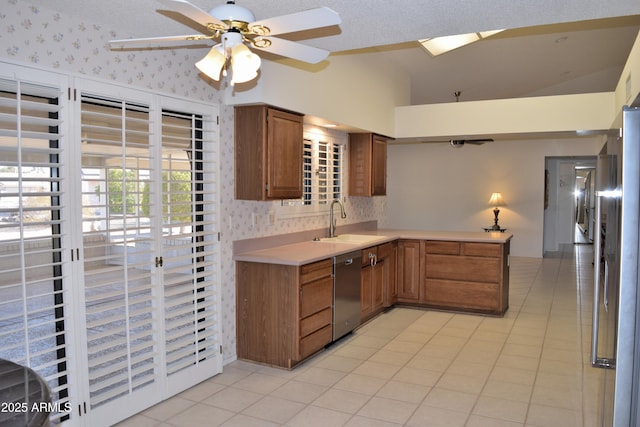 kitchen featuring appliances with stainless steel finishes, vaulted ceiling, ceiling fan, sink, and light tile patterned floors