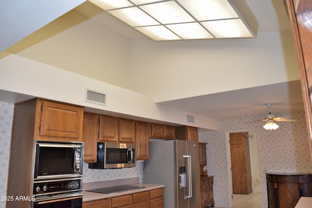 kitchen featuring ceiling fan and black appliances