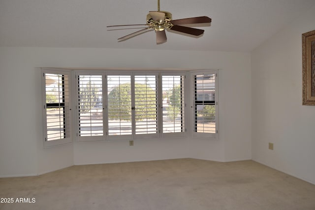 empty room featuring ceiling fan and light colored carpet