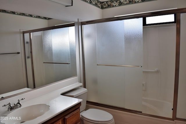 full bathroom with vanity, toilet, and bath / shower combo with glass door