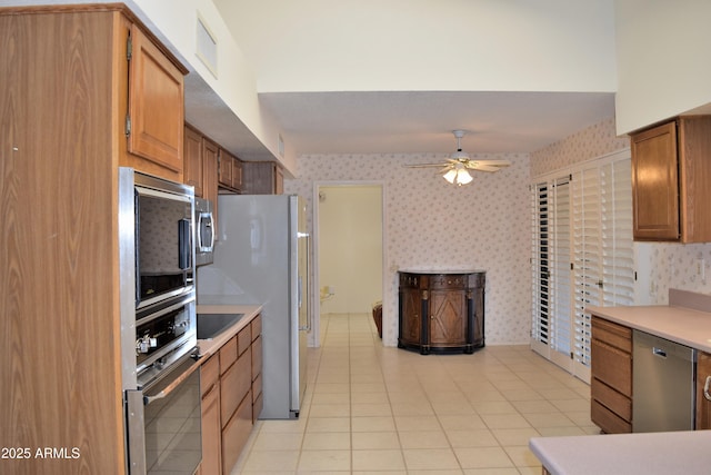 kitchen with black appliances, ceiling fan, and light tile patterned flooring