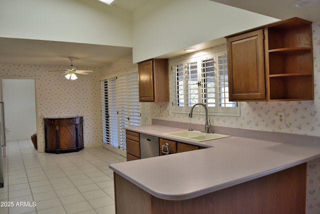 kitchen with ceiling fan, dishwasher, sink, kitchen peninsula, and light tile patterned floors