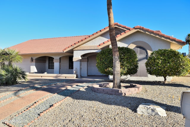 mediterranean / spanish house with a garage