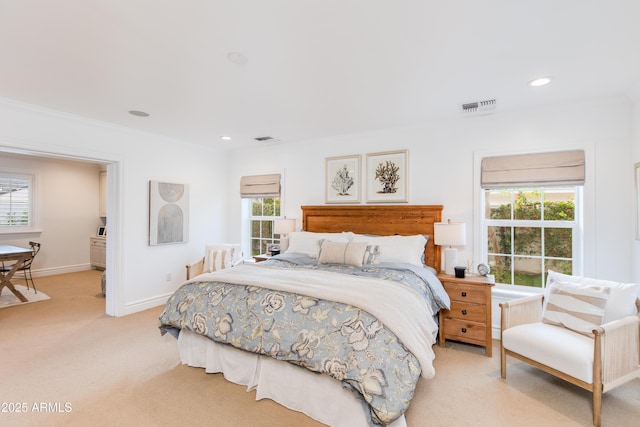 bedroom featuring multiple windows, visible vents, and light carpet