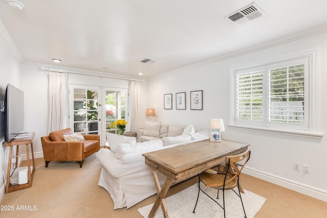 living room featuring light colored carpet, crown molding, french doors, and visible vents