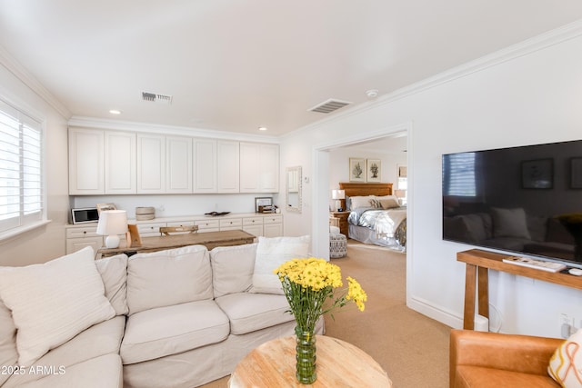 carpeted living area featuring recessed lighting, visible vents, and ornamental molding