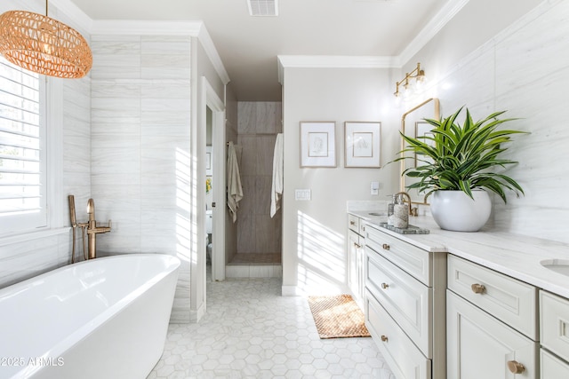 full bath with visible vents, double vanity, a freestanding tub, a tile shower, and ornamental molding