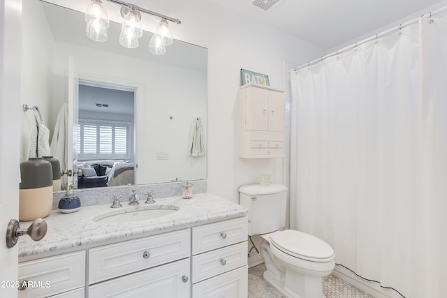 ensuite bathroom featuring tile patterned flooring, visible vents, connected bathroom, toilet, and vanity