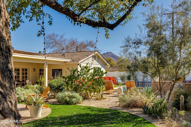 view of yard with french doors and fence