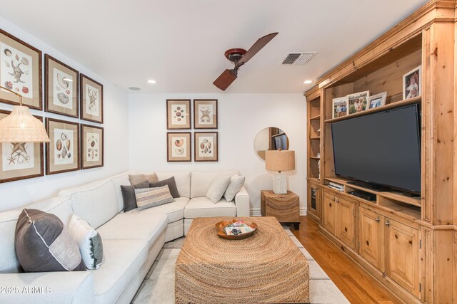 living area featuring recessed lighting, visible vents, baseboards, and light wood finished floors