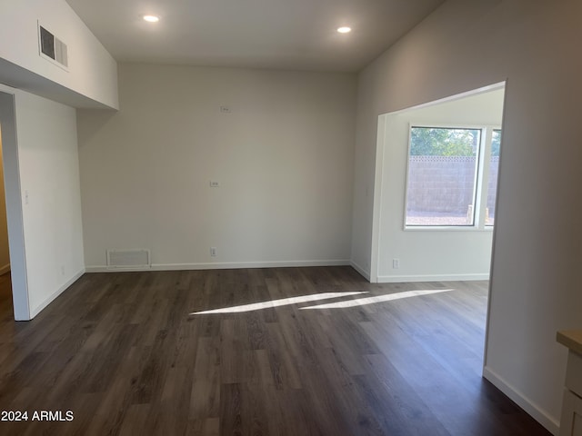 spare room featuring dark hardwood / wood-style flooring