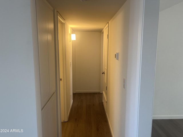 corridor with dark wood-type flooring