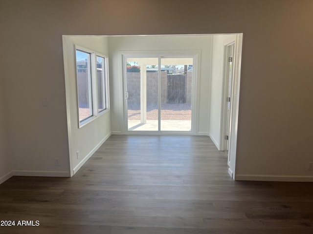 empty room with dark hardwood / wood-style floors