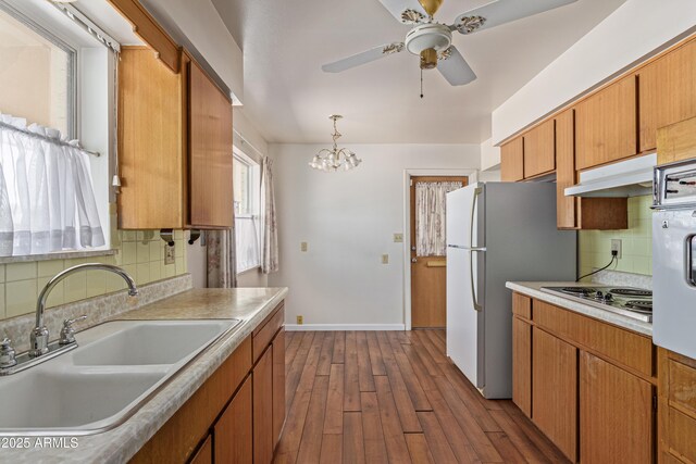 5309 E Butte St, Mesa, AZ 85205 - kitchen with white appliances, under cabinet range hood, dark wood-style flooring, backsplash, and light countertops