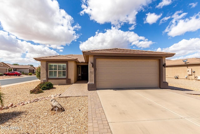 view of front of property featuring a tile roof, driveway, an attached garage, and stucco siding