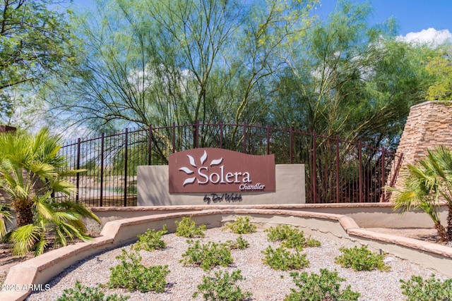 community sign featuring fence