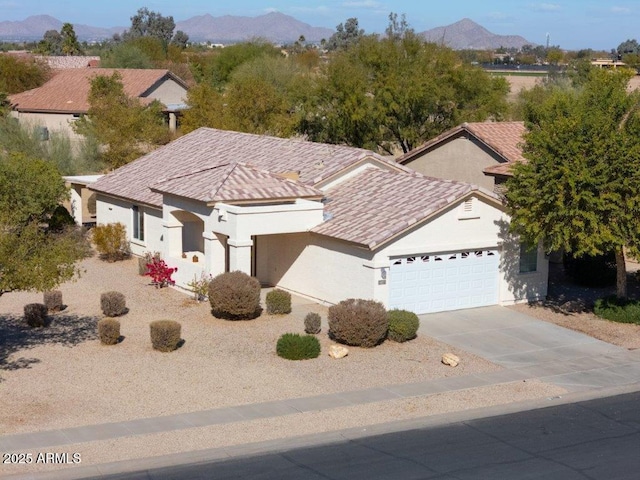 view of front of property featuring a mountain view and a garage