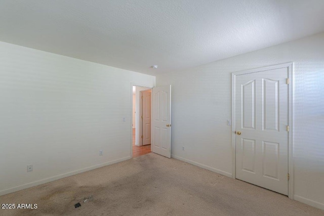 empty room featuring light colored carpet